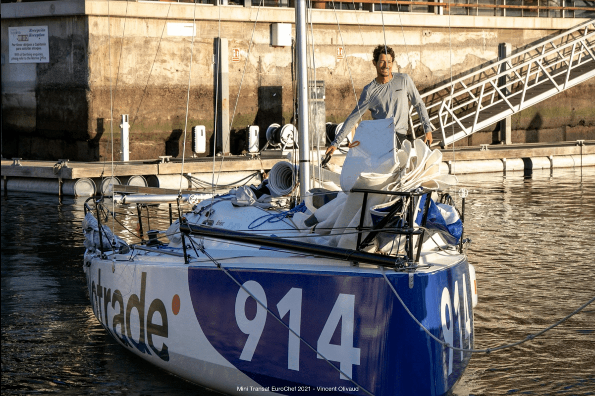 Front shot of the Velotrade sailboat with our skipper standing on board smiling as he finishes Leg 1.